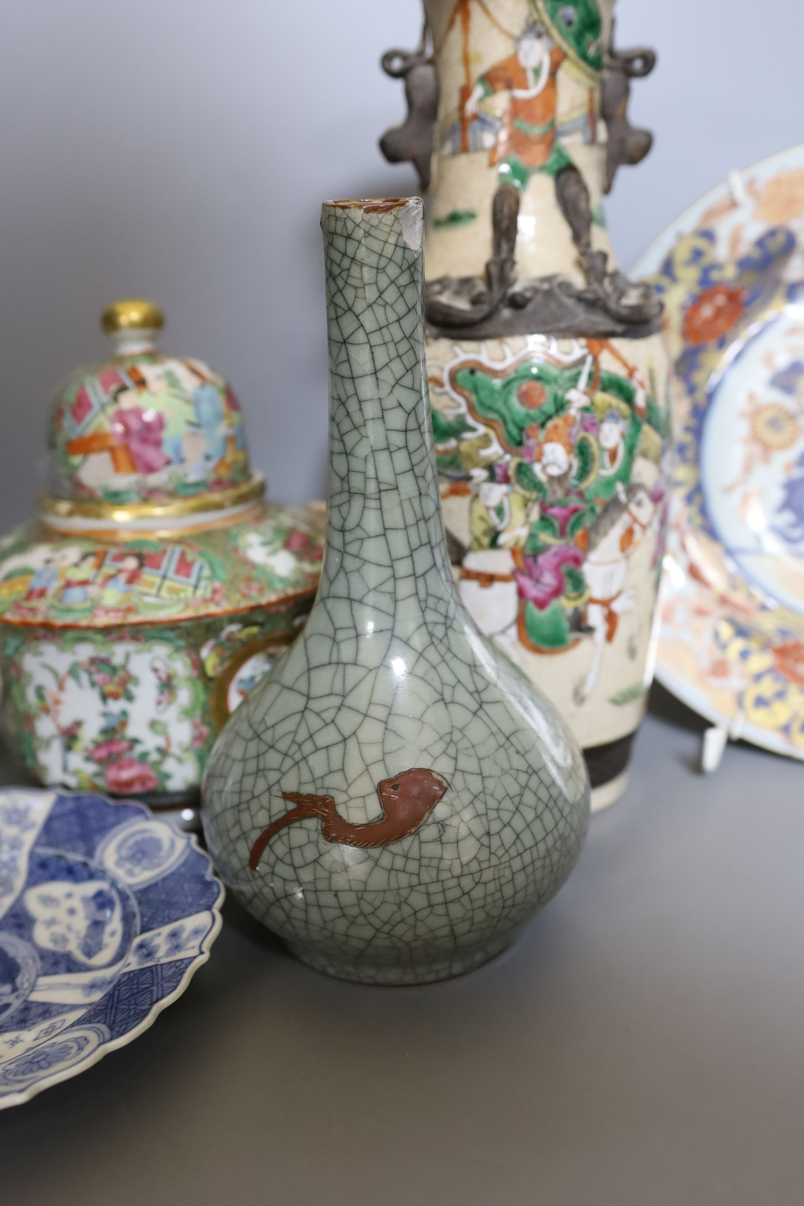 Three Chinese plates including a 19th century Chinese Imari dish, 23cm - repaired, a Chinese famille rose crackleglaze vase, 29cm, together with a famille rose teapot and a crackleglaze celadon ground bottle vase. Talles